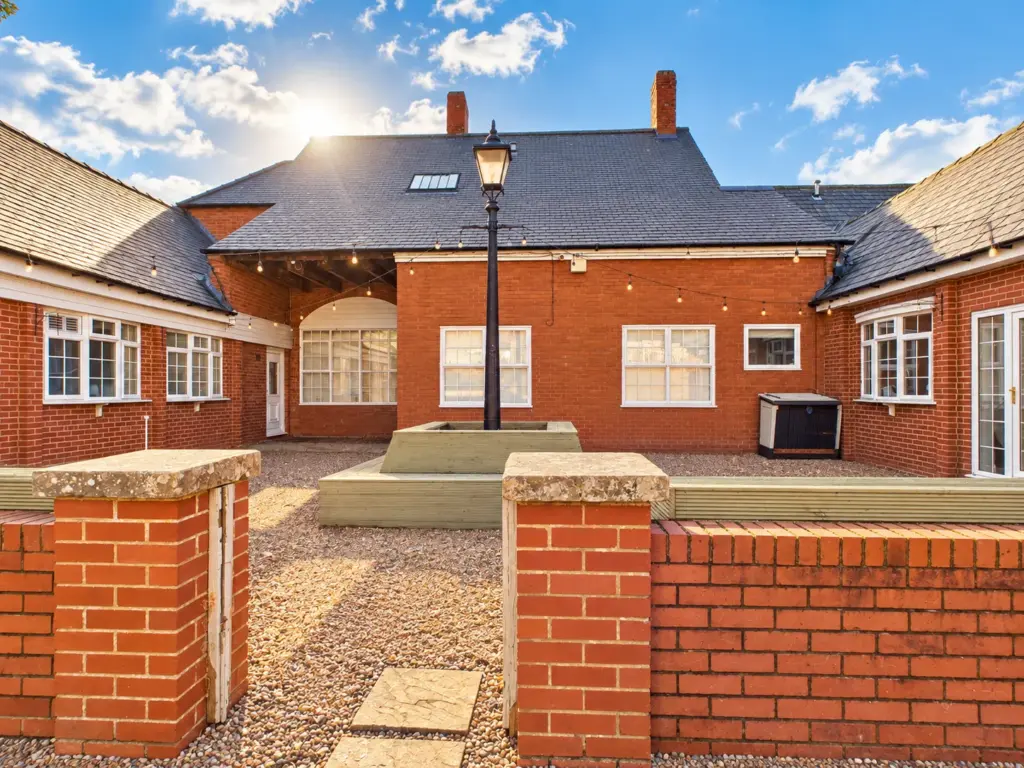 Sunny Brick Courtyard with String Lights
