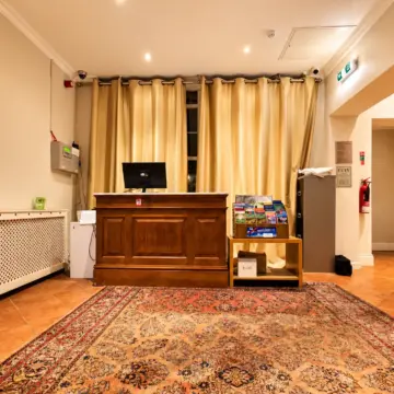 Warm Hotel Reception with Brochure Stand